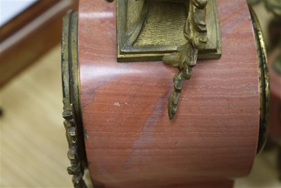 An early 20th century French pink marble clock garniture, 13.5in.